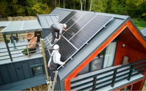 Two technicians working on installing solar panels on the roof of a residential home.